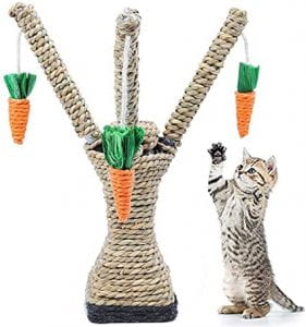 A cat reaches for woven carrots dangling from a cat tree.